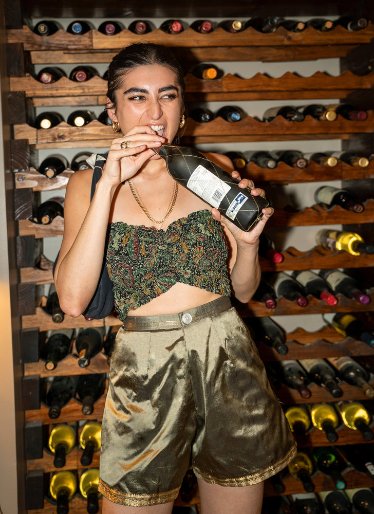 Perfect sustainable summer outfit. Upcycled gold raw silk shorts - high-waisted, wide-leg, and short-length. Styled with stretchy tube top. Wine not included!