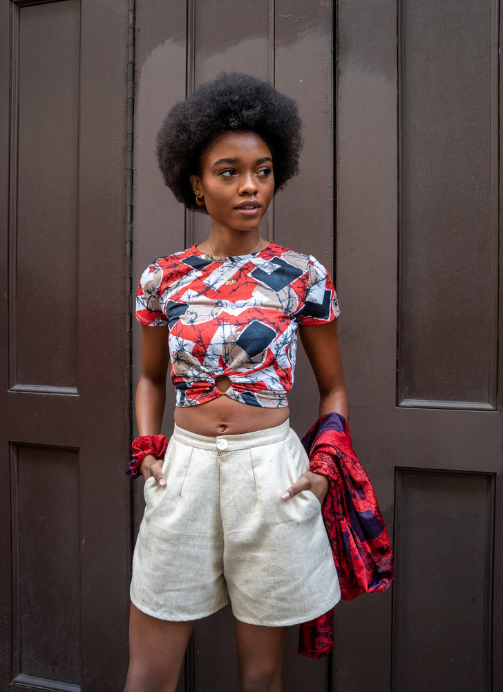 Perfect sustainable spring outfit. Upcycled gold raw silk shorts - high-waisted, wide-leg, and short-length. Styled on Black model with red tee and matching scrunchie.