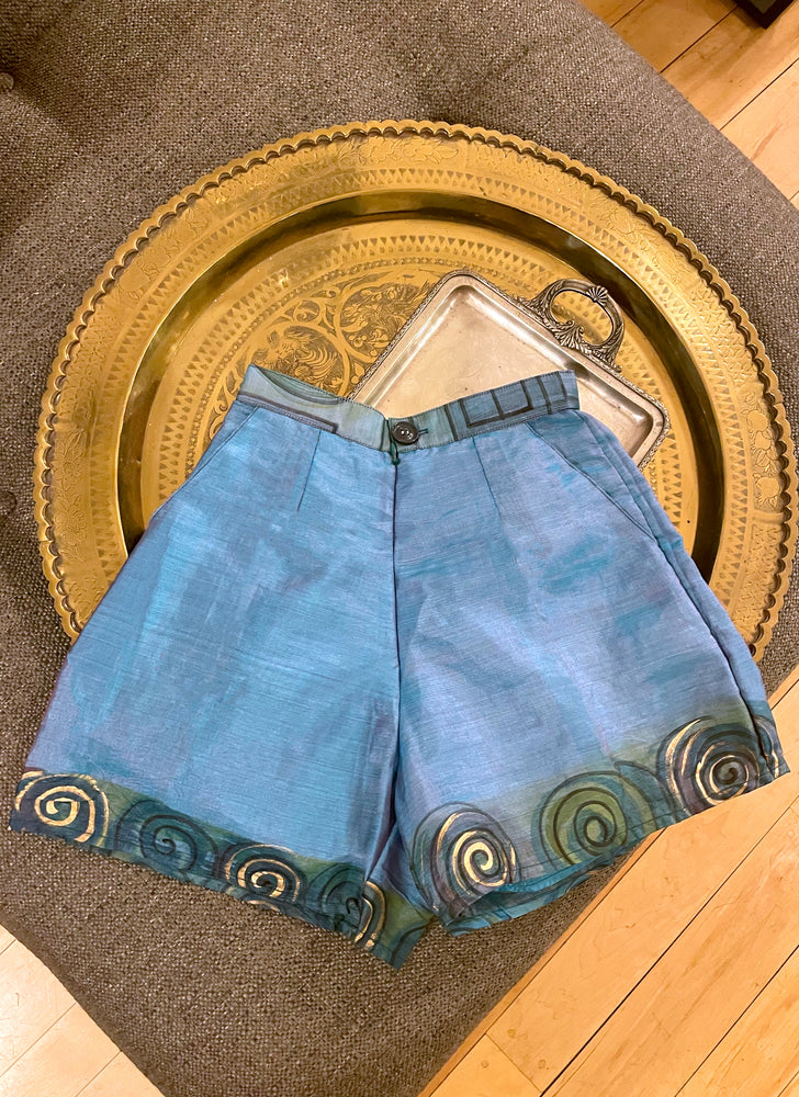 Perfect sustainable summer outfit. Upcycled hawaiian turquoise teal raw silk shorts - high-waisted, wide-leg, and short-length.