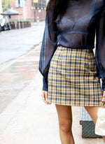 Our cult-fav mini skirt: A-line, high-rise, and made of vintage fabric. Tweed plaid print, very clueless!