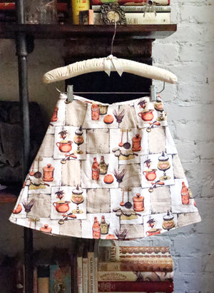 
                  
                    load image into gallery viewer,  High-waisted A-line mini skirt sustainably made using upcycled vintage fabric. Kitchen print (very Lisa Says Gah!)
                  
                