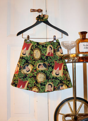 
                  
                    load image into gallery viewer, 1970s christmas outfit: A-line mini skirt covered in Elvis Presley Christmas print 
                  
                