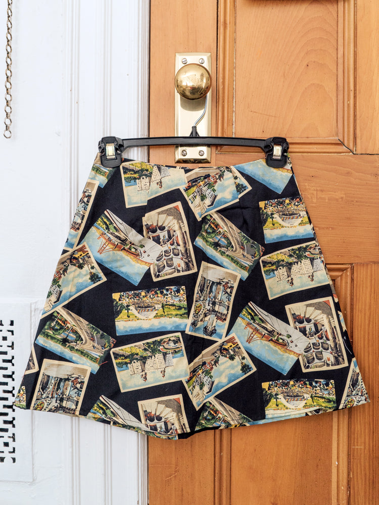 
                  
                    load image into gallery viewer, Postcard-printed high-waisted A-line mini skirt. Sustainably upcycled using vintage fabric. Made locally in NY.
                  
                
