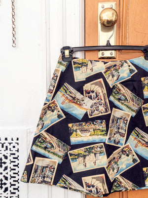 
                  
                    load image into gallery viewer, Postcard-printed high-waisted A-line mini skirt. Sustainably upcycled using vintage fabric. Made locally in NY.
                  
                