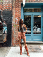 Perfect summer shorts - high-waisted, wide-leg, and short-length. Styled with a scarf top, oval sunglasses, and matching scrunchie on Black model.