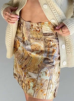 High-waisted A-line mini skirt sustainably made using upcycled vintage fabric. Goddess print, very 1970s art nouveau.